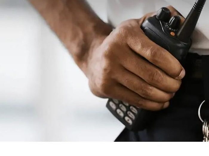 Close-up of a handheld two-way radio carried on a belt