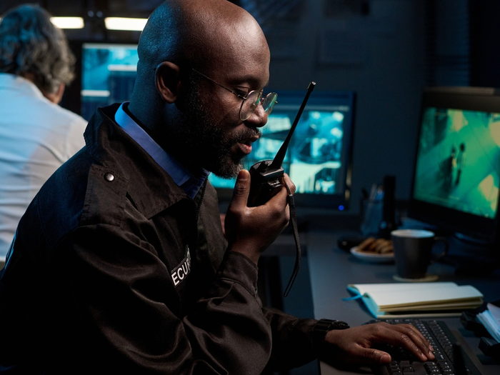 Security control room with live camera feeds on screen
